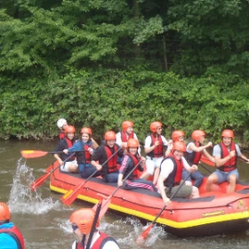 Menschen im Schlauchboot legen sich ordentlich ins Ruder