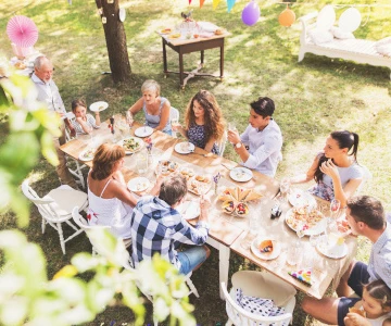 Personen sitzen an einem Tisch und essen gemütlich
