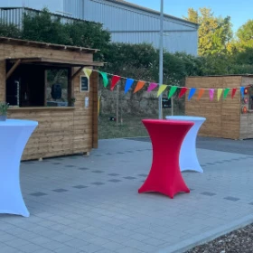 kleine Holzhütten mit Stehtischen davor