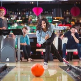Person hat die Bowlingkugel geworfen und schaut zu