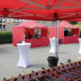 EVINTA_Firmen Sommerfest auf Ihrem Betriebsgelände_Bild01 rote Pavillons, weiße Stehtische, XXL Tischkicker